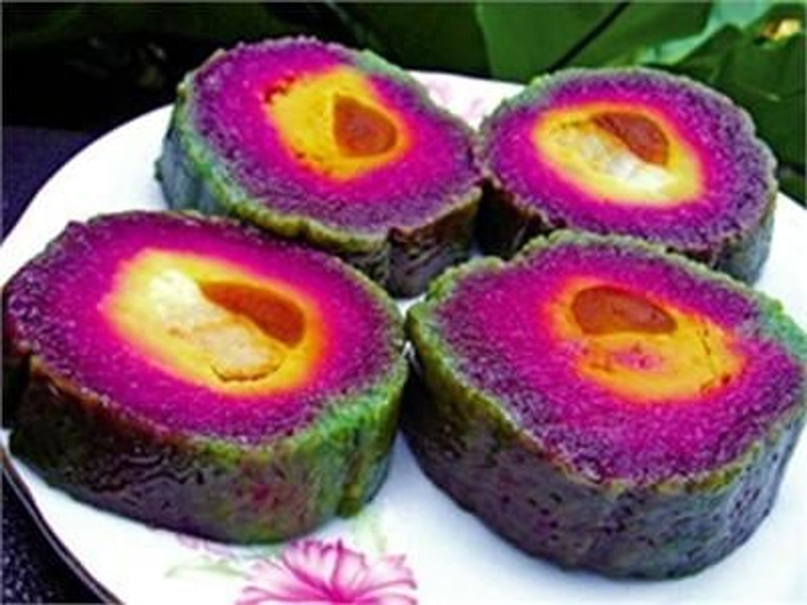 Slices of bánh tét lá cẩm with salted duck egg yolk · Photo: Tienduongproduction / CC BY-SA 4.0 (Wikimedia Commons)